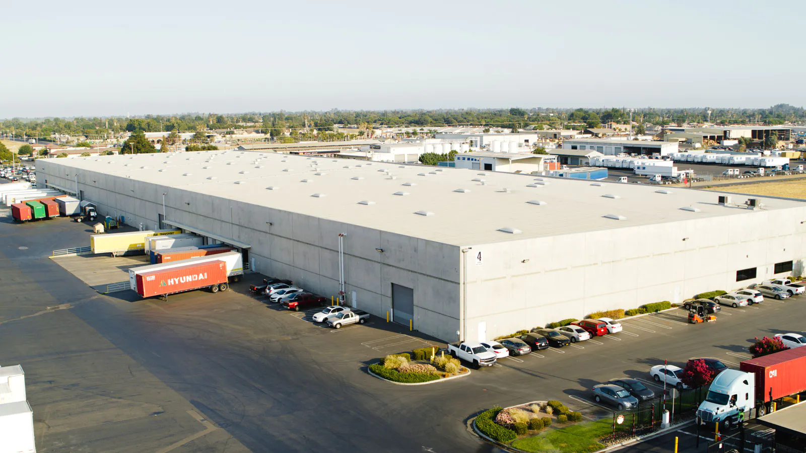 Aerial view of a large commercial rooftop solar array covering a warehouse facility
